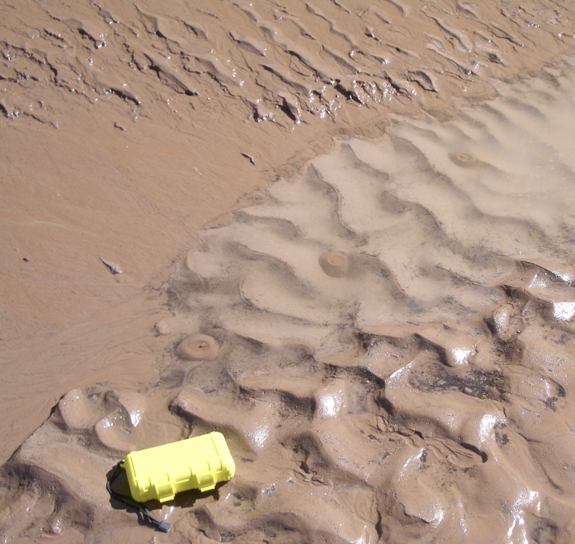 Several boils seeping from the sandbar immediately upstream of Crystal Rapid at a flow of approximately 8,000 cfs (the current low flow level). The yellow case is approximately 6.5 inches by 4 inches.