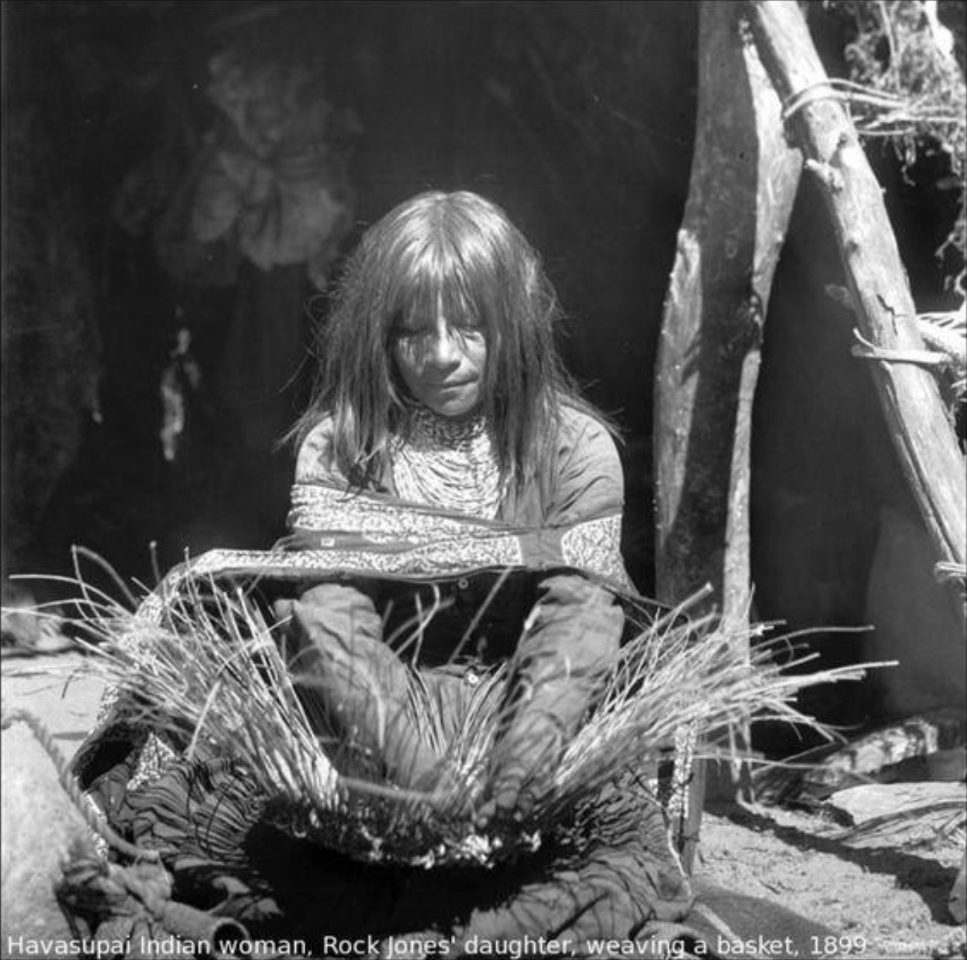 A Havasupi Native American woman weaves a basket.